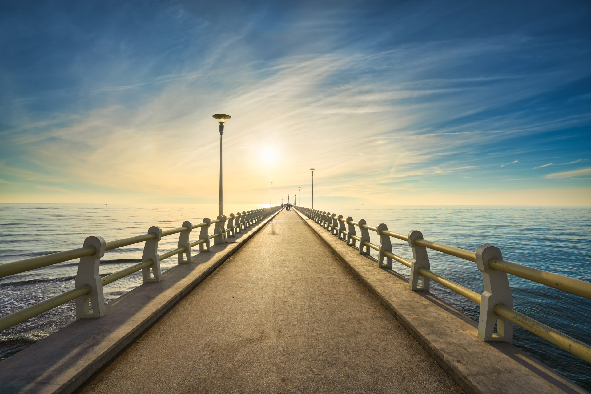 Pier or jetty, footpath promenade and sea in Forte dei Marmi at sunset. Versilia Lucca Tuscany Italy